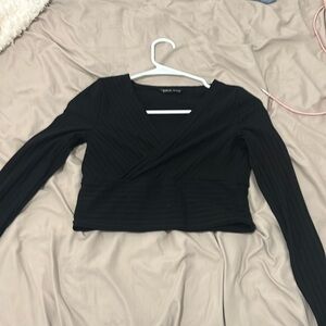A black long sleeve V-neck crop top